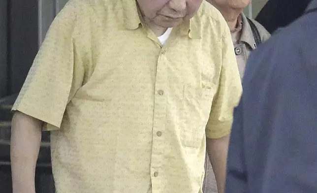 Iwao Hakamada, left, who has been sentenced to death in a 1966 quadruple murder case, leaves a detention center in Tokyo with his sister Hideko Hakamada, on March 27, 2014 after the Shizuoka District Court ordered a retrial. Japanese prosecutors said on Oct. 8, 2024 they will not appeal the Sept. 26 ruling of the Shizuoka District Court that acquitted the world’s longest-serving death-row inmate in a retrial. (Kyodo News via AP)