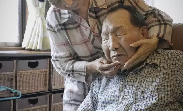 Hideko Hakamada, left, sister of former boxer Iwao Hakamada who has been on death row for a 1966 quadruple murder case, puts moisturizer on her brother's face after shaving, in Hamamatsu, Shizuoka prefecture, central Japan, on Aug. 20, 2021. Japanese prosecutors said on Oct. 8, 2024 they will not appeal the Sept. 26 ruling of the Shizuoka District Court that acquitted the world’s longest-serving death-row inmate in a retrial. (Kyodo News via AP)