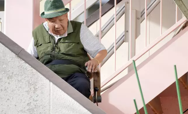 Iwao Hakamada, who was on death row for nearly a half-century and was acquitted last month by the Shizuoka District Court, prepares to go out for a walk in Hamamatsu, Shizuoka prefecture, central Japan, Thursday, Oct. 17, 2024. (AP Photo/Eugene Hoshiko)