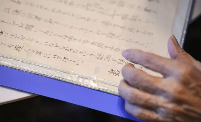 Hideko Hakamada, sister of Iwao Hakamada, shows a letter from her brother to his mother during an interview with The Associated Press in Hamamatsu, Shizuoka prefecture, central Japan, Thursday, Oct. 17, 2024. (AP Photo/Eugene Hoshiko)