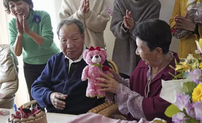 Iwao Hakamada, front left, who has been sentenced to death in a 1966 quadruple murder case, presents a stuffed toy bear to his sister Hideko Hakamada, right, on her 91st birthday in Hamamatsu, Shizuoka prefecture, central Japan, on Feb. 8, 2024. Japanese prosecutors said on Oct. 8, 2024 they will not appeal the Sept. 26 ruling of the Shizuoka District Court that acquitted the world’s longest-serving death-row inmate in a retrial. (Kyodo News via AP)