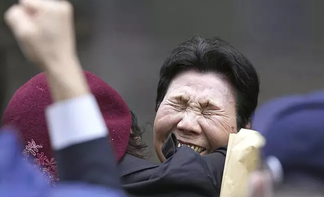 Hideko Hakamada, center right, sister of former boxer Iwao Hakamada who has been on death row for a 1966 quadruple murder case, celebrates with a supporter after Tokyo High Court granted a retrial for her brother in front of the court in Tokyo, on March 13, 2023. Japanese prosecutors said on Oct. 8, 2024 they will not appeal the Sept. 26 ruling of the Shizuoka District Court that acquitted the world’s longest-serving death-row inmate in a retrial. (Kyodo News via AP)