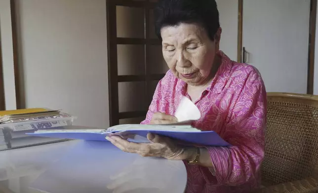 Hideko Hakamada, sister of former boxer Iwao Hakamada who has been on death row for the 1966 murder case, rereads letters that her brother wrote from prison, in Hamamatsu, Shizuoka prefecture, central Japan, in May 2024. Japanese prosecutors said on Oct. 8, 2024 they will not appeal the Sept. 26 ruling of the Shizuoka District Court that acquitted the world’s longest-serving death-row inmate in a retrial. (Kyodo News via AP)