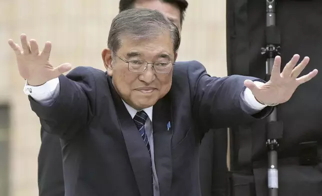 Japan's Prime Minister and head of the governing Liberal Democratic Party Shigeru Ishiba waves during a campaign for a parliamentary election in Tokyo, Japan, Saturday, Oct. 26, 2024. (Kyodo News via AP)