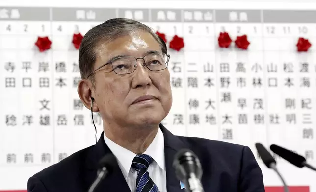 Japan's Prime Minister and president of the Liberal Democratic Party (LDP) Shigeru Ishiba pause as he speaks to the media regarding the early result of lower house election, at the LDP headquarters Sunday, Oct. 27, 2024, in Tokyo, (Kyodo News via AP)