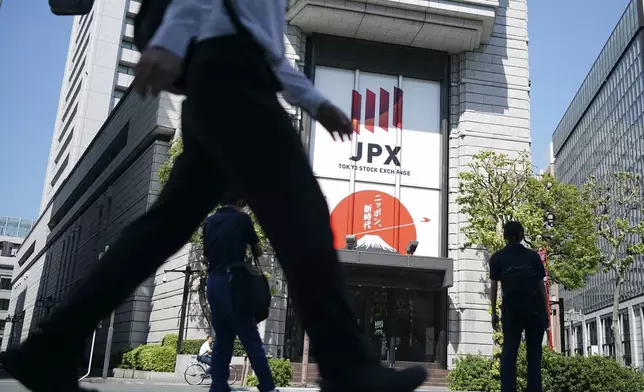 FILE - A person walks in front of the Tokyo Stock Exchange building Wednesday, Oct. 2, 2024, in Tokyo. (AP Photo/Eugene Hoshiko, File)