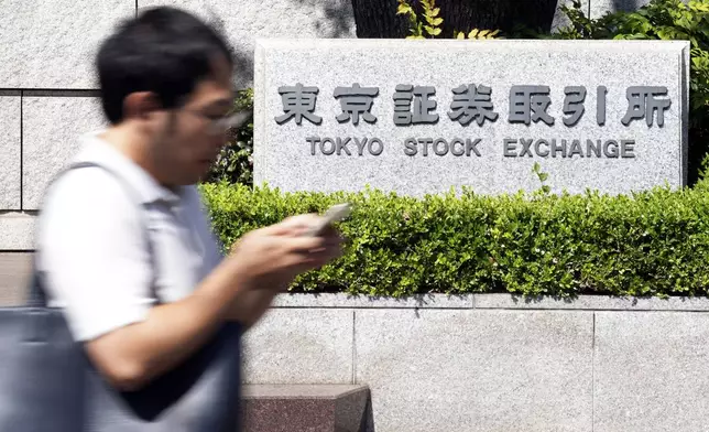 A person walks in front of the Tokyo Stock Exchange building Wednesday, Oct. 2, 2024, in Tokyo. (AP Photo/Eugene Hoshiko)