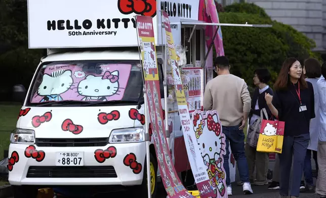 A food vendor's van is decorated with Hello Kitty images outside the National Museum during the exhibition "As I change, so does she," marking the 50th anniversary of Hello Kitty at the National Museum in Tokyo Wednesday, Oct. 30, 2024. (AP Photo/Shuji Kajiyama)