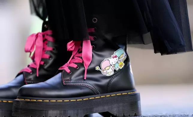 A visitor wears boots featuring Hello Kitty at the National Museum during the exhibition "As I change, so does she," marking the 50th anniversary of Hello Kitty at the Tokyo National Museum in Tokyo Wednesday, Oct. 30, 2024. (AP Photo/Shuji Kajiyama)