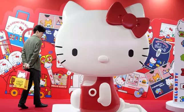 A visitor looks at giant Hello Kitty display at the exhibition "As I change, so does she," marking the 50th anniversary of Hello Kitty at the Tokyo National Museum in Tokyo Wednesday, Oct. 30, 2024. (AP Photo/Shuji Kajiyama)