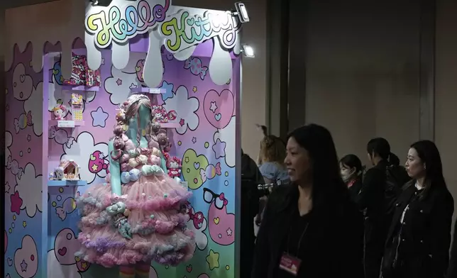 Visitors look at giant Hello Kitty decorations at the exhibition "As I change, so does she," marking the 50th anniversary of Hello Kitty at the Tokyo National Museum in Tokyo Wednesday, Oct. 30, 2024. (AP Photo/Shuji Kajiyama)