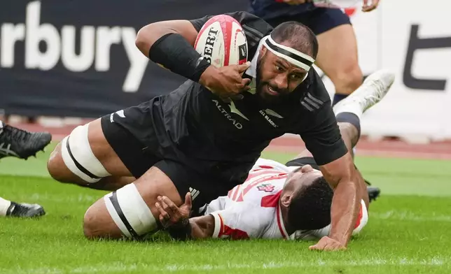 New Zealand's Patrick Tuipulotu reaches out to score a try during a rugby test match between the All Blacks and Japan at Nissan Stadium in Yokohama, near Tokyo, Saturday, Oct. 26, 2024. (AP Photo/Shuji Kajiyama)