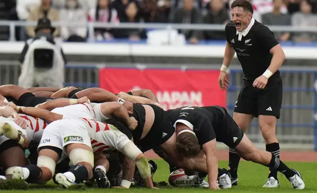 New Zealand's Cam Roigard, right, reactsduring a rugby test match between the All Blacks and Japan at Nissan Stadium in Yokohama, near Tokyo, Saturday, Oct. 26, 2024. (AP Photo/Shuji Kajiyama)