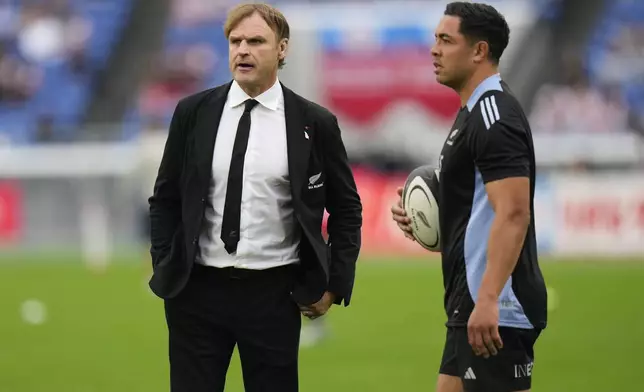 New Zealand coach Scott Robertson, left, stands with his inside centre Anton Lienert-Brown as they warm up ahead of the rugby test match between the All Blacks and Japan at Nissan Stadium in Yokohama, near Tokyo, Saturday, Oct. 26, 2024. (AP Photo/Shuji Kajiyama)