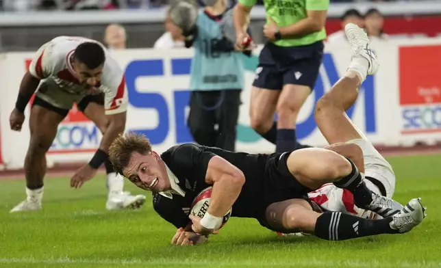 New Zealand's Ruben Love reaches out to score a try during a rugby test match between the All Blacks and Japan at Nissan Stadium in Yokohama, near Tokyo, Saturday, Oct. 26, 2024. (AP Photo/Shuji Kajiyama)