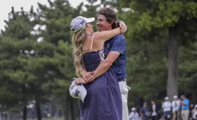 Nico Echavarria of Colombia celebrates with his girlfriend after winning the PGA Tour Zozo Championship at the Narashino Country Club in Inzai on the outskirts of Tokyo, Sunday, Oct. 27, 2024. (AP Photo/Tomohiro Ohsumi)