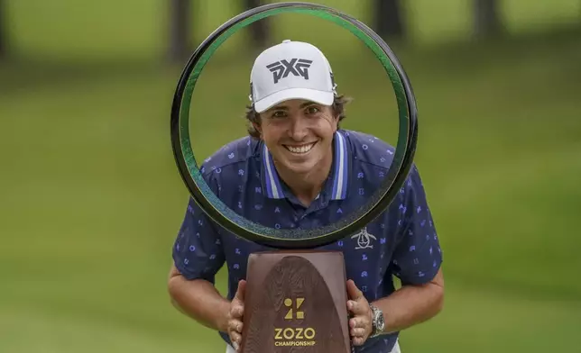 Nico Echavarria of Colombia poses with the trophy after winning the PGA Tour Zozo Championship at the Narashino Country Club in Inzai on the outskirts of Tokyo, Sunday, Oct. 27, 2024. (AP Photo/Tomohiro Ohsumi)