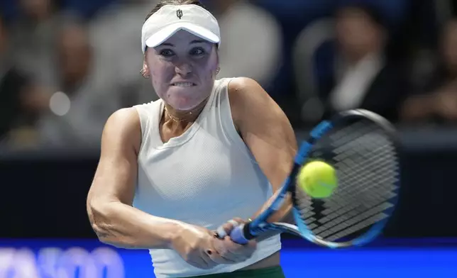 Sofia Kenin of the United States returns a shot against China's Zheng Qinwen during the final match of the Pan Pacific Open women's tennis tournament at Ariake Coliseum, in Tokyo, Sunday, Oct. 27, 2024. (AP Photo/Eugene Hoshiko)