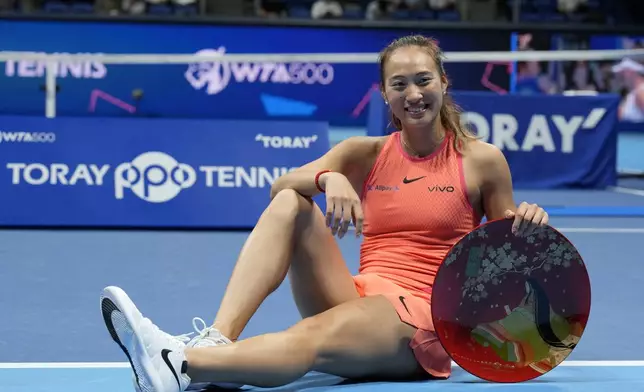 China's Zheng Qinwen poses with her trophy after winning the Pan Pacific Open women's tennis tournament at Ariake Coliseum, in Tokyo, Sunday, Oct. 27, 2024. (AP Photo/Eugene Hoshiko)