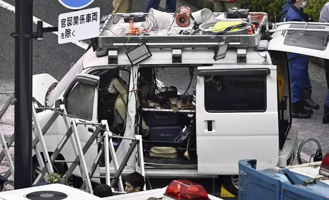 A vehicle is stuck against a barricade near the prime minister's office in Tokyo Saturday, Oct. 19, 2024. (Kyodo News via AP)