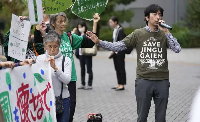 Protest leader Satoru Osawa, right, a Tokyo resident, speaks as environmentalists hold a rally near the Jingu Gaien park district of central Tokyo, Japan, as property developer Mitsui Fudosan begins cutting trees as part of the redevelopment of the area, Monday, Oct. 28, 2024. (AP Photo/Hiro Komae)