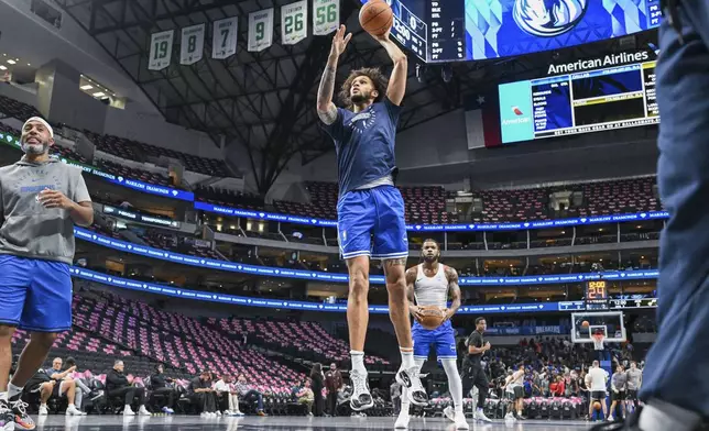 Dallas Mavericks center Dereck Lively II, center front, warms up before an NBA basketball game against the Utah Jazz, Monday, Oct. 28, 2024, in Dallas. (AP Photo/Albert Pena)