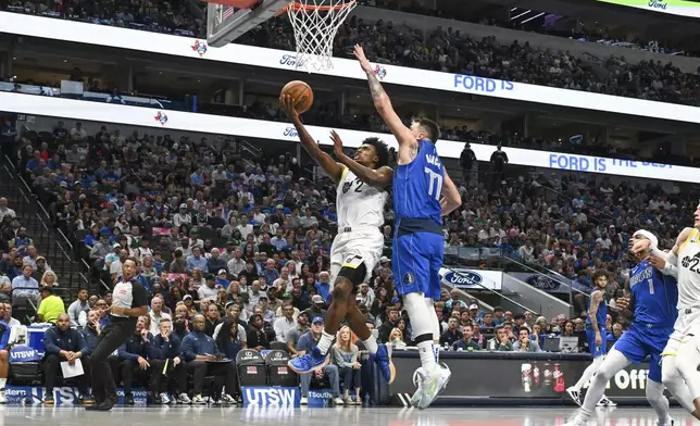 Utah Jazz guard Collin Sexton (2) goes up for a basket as he is defended by Dallas Mavericks guard Luka Doncic (77) in the first half of an NBA basketball game, Monday, Oct. 28, 2024, in Dallas. (AP Photo/Albert Pena)