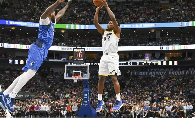 Utah Jazz guard Collin Sexton (2) takes a jump shot over Dallas Mavericks forward Naji Marshall, left, in the first half of an NBA basketball game, Monday, Oct. 28, 2024, in Dallas. (AP Photo/Albert Pena)