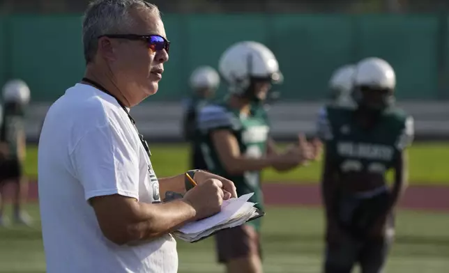 Coach Jim Davis attends a training session at the football field of the U.S. Naval Support – Site in Gricignano di Aversa, southern Italy, Tuesday, Oct. 29, 2024. (AP Photo/Gregorio Borgia)