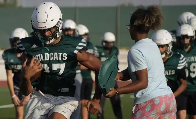 Wildcats team players practice during a training session at the football field of the U.S. Naval Support – Site in Gricignano di Aversa, southern Italy, Tuesday, Oct. 29, 2024. (AP Photo/Gregorio Borgia)