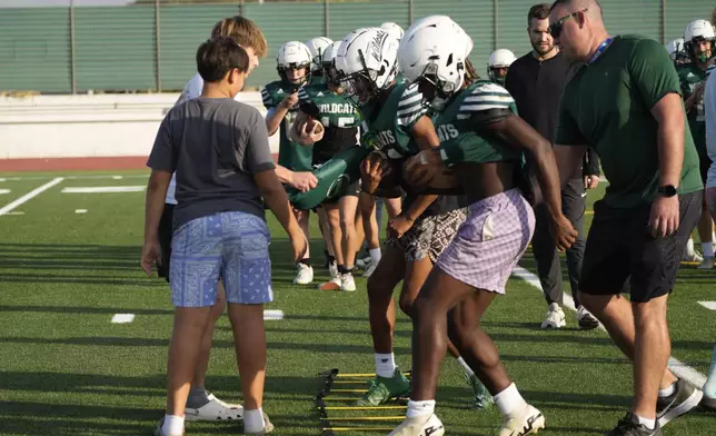 Wildcats team players practice during a training session at the football field of the U.S. Naval Support – Site in Gricignano di Aversa, southern Italy, Tuesday, Oct. 29, 2024. (AP Photo/Gregorio Borgia)