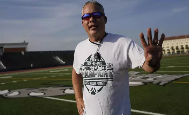 Coach Jim Davis is interviewed by The Associated Press prior to the start of a training session at the football field of the U.S. Naval Support – Site in Gricignano di Aversa, southern Italy, Tuesday, Oct. 29, 2024. (AP Photo/Gregorio Borgia)