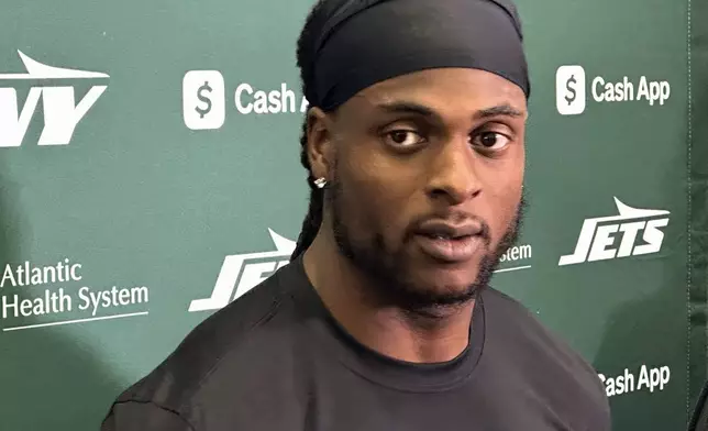 New York Jets wide receiver Davante Adams speaks to reporters at the team's facility in Florham Park, N.J., on Wednesday, Oct. 16, 2024. (AP Photo/Dennis Waszak Jr.)