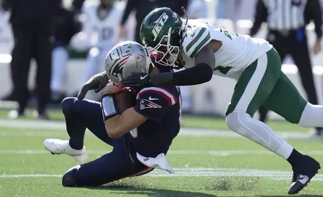 New England Patriots quarterback Drake Maye (10) connects helmet to helmet from behind with New York Jets linebacker Jamien Sherwood (44) in the first half of an NFL football game, Sunday, Oct. 27, 2024, in Foxborough, Mass. (AP Photo/Charles Krupa)