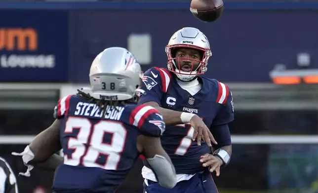 New England Patriots quarterback Jacoby Brissett, right, passes to running back Rhamondre Stevenson, left, in the second half of an NFL football game against the New York Jets, Sunday, Oct. 27, 2024, in Foxborough, Mass. (AP Photo/Michael Dwyer)