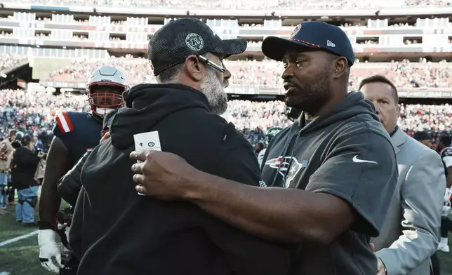 New York Jets interim head coach Jeff Ulbrich, left, and New England Patriots head coach Jerod Mayo, right, greet in the middle of the field following an NFL football game, Sunday, Oct. 27, 2024, in Foxborough, Mass. (AP Photo/Michael Dwyer)