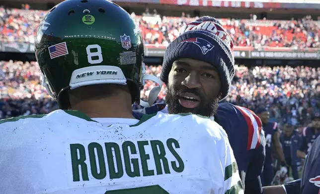 New York Jets quarterback Aaron Rodgers, left, and New England Patriots quarterback Jacoby Brissett, right, meet in the middle of the field following an NFL football game, Sunday, Oct. 27, 2024, in Foxborough, Mass. (AP Photo/Charles Krupa)