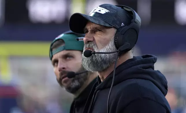 Dallas Stars interim head coach Jeff Ulbrich, right, looks up toward the scoreboard in the second half of an NFL football game against the New England Patriots, Sunday, Oct. 27, 2024, in Foxborough, Mass. (AP Photo/Michael Dwyer)