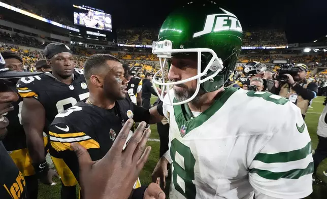 Pittsburgh Steelers quarterback Russell Wilson (3) greets New York Jets quarterback Aaron Rodgers (8) after an NFL football game in Pittsburgh, Sunday, Oct. 20, 2024. The Steelers won 37-15. (AP Photo/Gene J. Puskar)