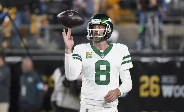 New York Jets quarterback Aaron Rodgers (8) warms up before an NFL football game against the Pittsburgh Steelers in Pittsburgh, Sunday, Oct. 20, 2024. (AP Photo/Matt Freed)