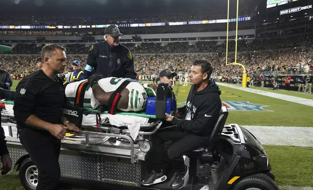 New York Jets guard Xavier Newman is carted off the field after being injured in the second half of an NFL football game against the Pittsburgh Steelers in Pittsburgh, Sunday, Oct. 20, 2024. (AP Photo/Matt Freed)