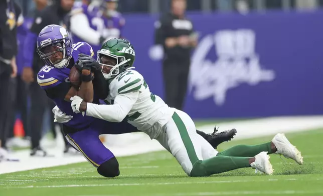 New York Jets' Tony Adams, right, tackles Minnesota Vikings' Justin Jefferson during the first half of an NFL football game, Sunday, Oct. 6, 2024, at the Tottenham Hotspur stadium in London. (AP Photo/Ian Walton)