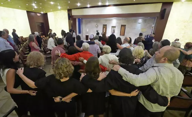 Worshipers sing as they pray for peace, during a Shabbat service, Friday, Sept. 27, 2024, at Temple Beth Sholom in Miami Beach, Fla. (AP Photo/Wilfredo Lee)