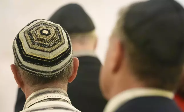 Men wear yarmulkes as they attend a Shabbat service, Friday, Sept. 27, 2024, at Temple Beth Sholom in Miami Beach, Fla. (AP Photo/Wilfredo Lee)