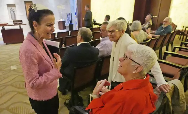 Gayle Pomerantz, left, senior rabbi at Temple Beth Sholom, chats with worshipers before the start of a Shabbat service, Friday, Sept. 27, 2024, in Miami Beach, Fla. (AP Photo/Wilfredo Lee)