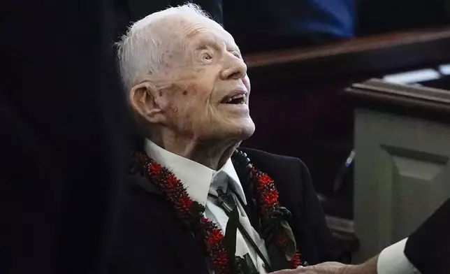 FILE - Former President Jimmy Carter greets attendees as he departs the funeral service for his wife, former first lady Rosalynn Carter, at Maranatha Baptist Church in Plains, Ga., Nov. 29, 2023. (AP Photo/Alex Brandon, Pool, File)