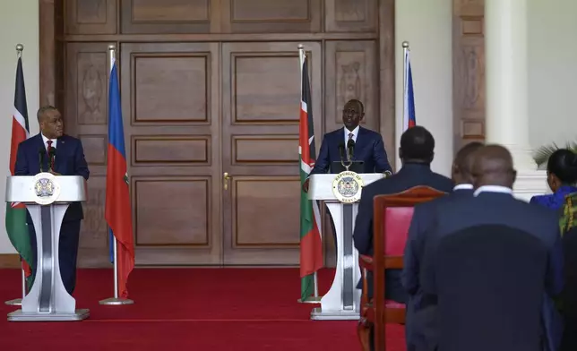 Haiti Prime Minister Garry Conille, left, and Kenya's President William Ruto, right, give a joint press conference at State House in Nairobi, Kenya, Friday, Oct. 11, 2024. (AP Photo/Brian Inganga)