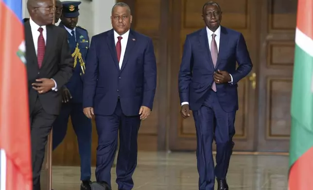 Haiti Prime Minister Garry Conille, left, and Kenya's President William Ruto, right, walk to give a joint press conference at State House in Nairobi, Kenya, Friday, Oct. 11, 2024. (AP Photo/Brian Inganga)