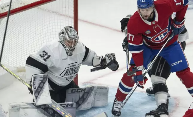 Montreal Canadiens' Josh Anderson (17) battles with Los Angeles Kings' Phillip Danault (24) in front of Los Angeles Kings goaltender David Rittich (31) during the first period of an NHL hockey game, Thursday, Oct. 17, 2024 in Montreal. (Ryan Remiorz/The Canadian Press via AP)