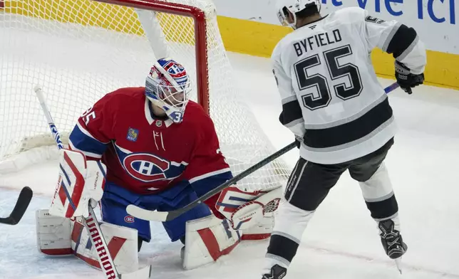 Montreal Canadiens goaltender Sam Montembeault (35) makes the save on Los Angeles Kings' Quinton Byfield (55) during the first period of an NHL hockey game, Thursday, Oct. 17, 2024 in Montreal. (Ryan Remiorz/The Canadian Press via AP)